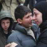 Mustafa Bani Odeh (left), his older brother Khaled, (center), at the funeral of their family of two parents and two other siblings who were killed by Israeli special forces when they were driving back to their hometown of Tammoun in the northern West Bank, March 15, 2026. (Photo: Mohammed Nasser/APA Images)
