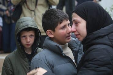 Mustafa Bani Odeh (left), his older brother Khaled, (center), at the funeral of their family of two parents and two other siblings who were killed by Israeli special forces when they were driving back to their hometown of Tammoun in the northern West Bank, March 15, 2026. (Photo: Mohammed Nasser/APA Images)