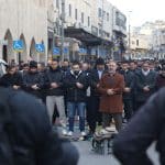 Israeli police watch as Palestinians pray outside the Old City of Jerusalem on the first day of Eid Al Fitr. The Al-Aqsa Mosque compound and other holy sites have remained closed since the start of the war with Iran on February 28, marking the first time the mosque has been shuttered for the holiday since 1967. (Credit Image: © Oren Ziv/dpa via ZUMA Press APA Images, 20 March 2026)