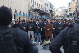 Israeli police watch as Palestinians pray outside the Old City of Jerusalem on the first day of Eid Al Fitr. The Al-Aqsa Mosque compound and other holy sites have remained closed since the start of the war with Iran on February 28, marking the first time the mosque has been shuttered for the holiday since 1967. (Credit Image: © Oren Ziv/dpa via ZUMA Press APA Images, 20 March 2026)