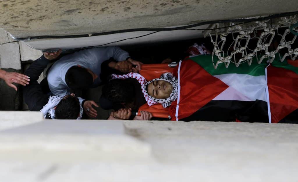 Palestinian mourners carry the body of 19-year old Jihad al-Jaafari, who was shot dead on the roof of his house after Israeli soldiers raided Dheisheh refugee camp at dawn in Bethlehem, February 24, 2015. (Photo: Shadi Hatem/APA Images)
