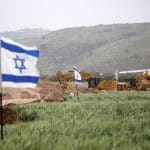 Jewish Israeli settlers set up mobile homes and raise Israeli flags over the evacuated settlement of Sanur, north of Nablus, which was approved by resettlement by the Israeli government in 2025, March 18, 2026. (Photo: Mohammed Nasser/APA Images)