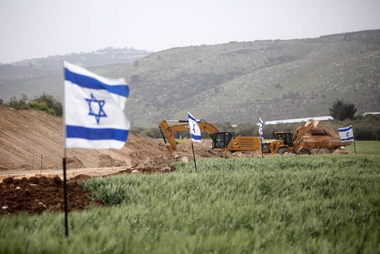 Jewish Israeli settlers set up mobile homes and raise Israeli flags over the evacuated settlement of Sanur, north of Nablus, which was approved by resettlement by the Israeli government in 2025, March 18, 2026. (Photo: Mohammed Nasser/APA Images)