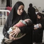 Yasmeen al-Jamala holds her newborn son, Adam al-Ustaz, who receives treatment at al-Rantisi Children's Hospital in Gaza City after being bitten by a rat inside a displacement tent, March 28, 2026. (Photo: Moiz Salhi/APA Images)
