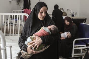 Yasmeen al-Jamala holds her newborn son, Adam al-Ustaz, who receives treatment at al-Rantisi Children's Hospital in Gaza City after being bitten by a rat inside a displacement tent, March 28, 2026. (Photo: Moiz Salhi/APA Images)