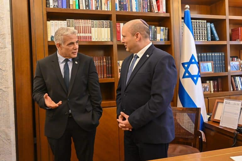 Naftali Bennett, right, and Yair Lapid, left, prepare to rotate the prime ministership during their first unity effort, on June 30, 2022. (Photo: Koby Gideon/Israel Gpo via ZUMA Press Wire/APA Images)