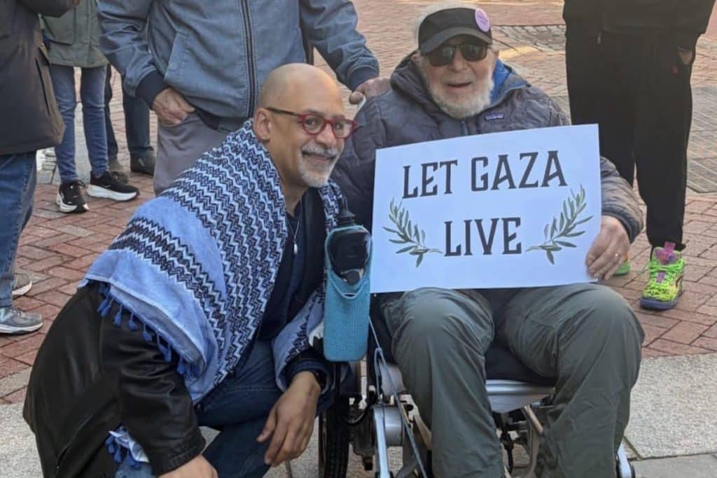 Chris Rabb takes a photo with a supporter at a vigil outside Sen. John Fetterman's Philadelphia office on February 27, 2026. (Photo: Instagram/chrisrabb)