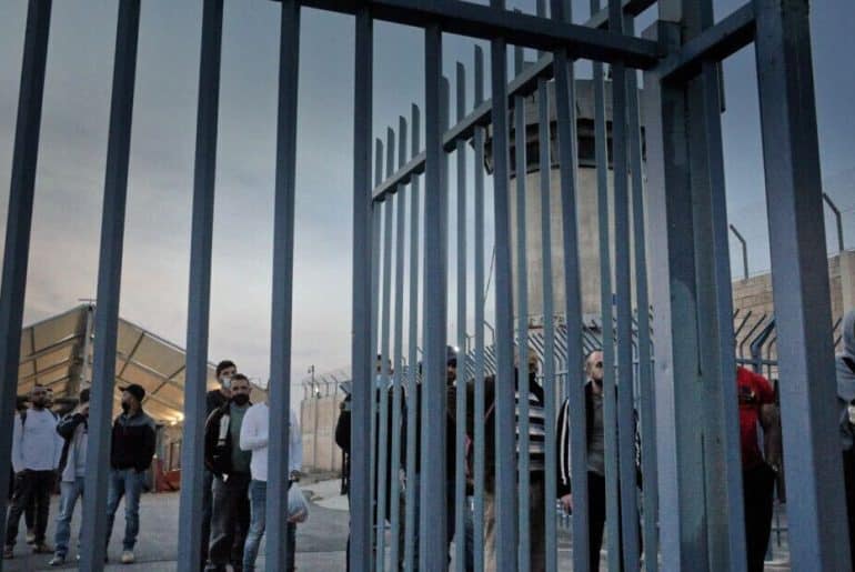 Palestinians in 2021 passing through Qalandia checkpoint on the way to work inside Israel. (Photo: Qassam Muaddi/Mondoweiss)