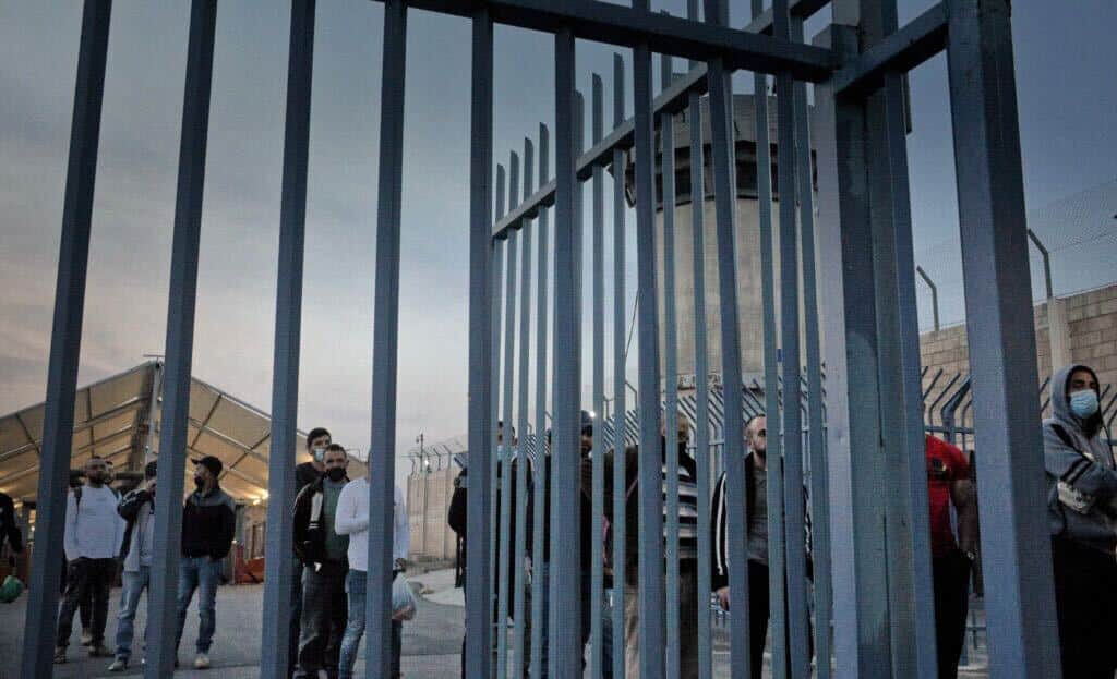 Palestinians in 2021 passing through Qalandia checkpoint on the way to work inside Israel. (Photo: Qassam Muaddi/Mondoweiss)