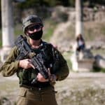 Israeli soldiers patrolling Roman-era ruins in the Palestinian town of Sebastia, March 30, 2021. (Photo: Shadi Jarar'ah/APA Images)