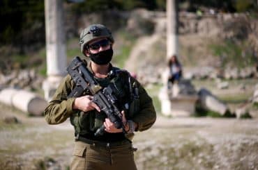 Israeli soldiers patrolling Roman-era ruins in the Palestinian town of Sebastia, March 30, 2021. (Photo: Shadi Jarar'ah/APA Images)