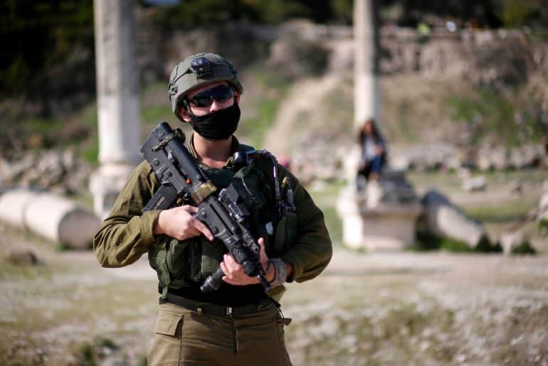 Israeli soldiers patrolling Roman-era ruins in the Palestinian town of Sebastia, March 30, 2021. (Photo: Shadi Jarar'ah/APA Images)