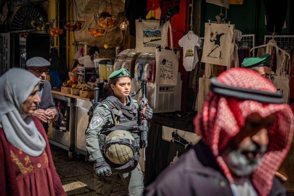 An Israeli soldier walks among Muslim worshippers in the Old City on the last Friday of the holy month of Ramadan, April 5, 2024. (Photo: © Ilia Yefimovich/dpa via ZUMA Press/APA Images)