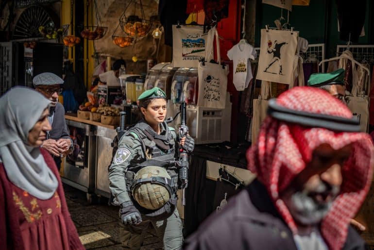 An Israeli soldier walks among Muslim worshippers in the Old City on the last Friday of the holy month of Ramadan, April 5, 2024. (Photo: © Ilia Yefimovich/dpa via ZUMA Press/APA Images)