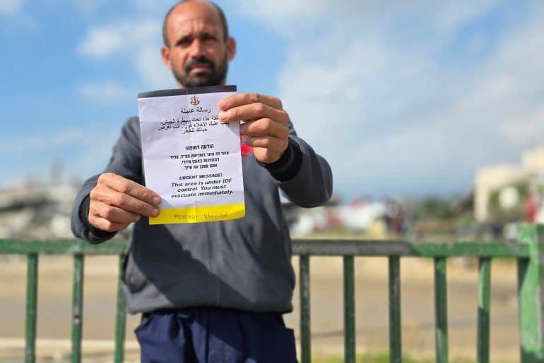 Israeli forces demolish a house near the "Yellow Line," dropping leaflets for residents to leave the al-Raqab al-Gharbi neighborhood, adjacent to Salah al-Din Street in the town of Bani Suheila, east of Khan Younis in the southern Gaza Strip, January 19, 2026. (Photo: Tariq Mohammad/APA Images)