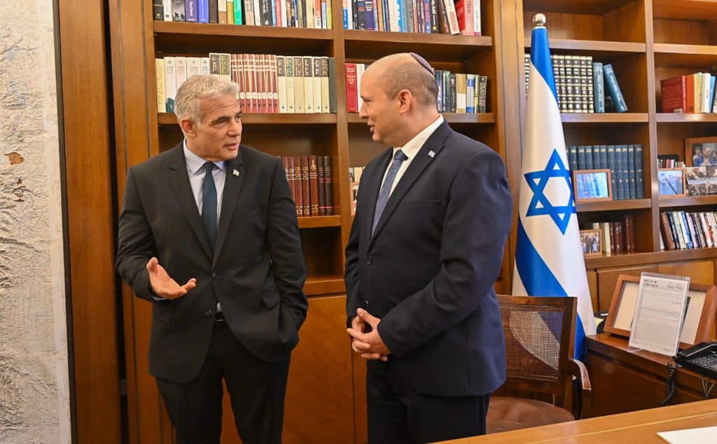 Outgoing Prime Minister Naftali Bennet (R) and incoming Prime Minister Yair Lapid (L) hold a transition meeting and handover ceremony at the Prime Minister's Office in Jerusalem, June 30, 2022. (Photo: Koby Gideon/Israel Gpo via ZUMA Press Wire\APA Images)