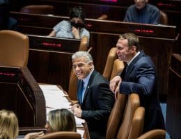 Yair Lapid (L) at a session of the Knesset ahead of a vote to dissolve the government, June 30, 2022. (Photo: Ilia Yefimovich/dpa via ZUMA Press/APA Images)