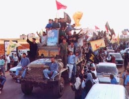 Hezbollah members and supporters parade following the end of Israel's occupation of southern Lebanon, May 2000. (Photo: Wikimedia Commons)