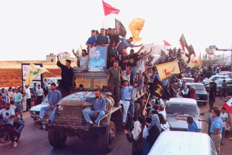 Hezbollah members and supporters parade following the end of Israel's occupation of southern Lebanon, May 2000. (Photo: Wikimedia Commons)
