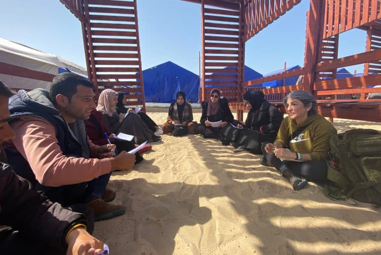 susan abulhawa, right, meeting with writers in Gaza in early 2024 for workshops that led to the book, "Every Moment Is A Life."