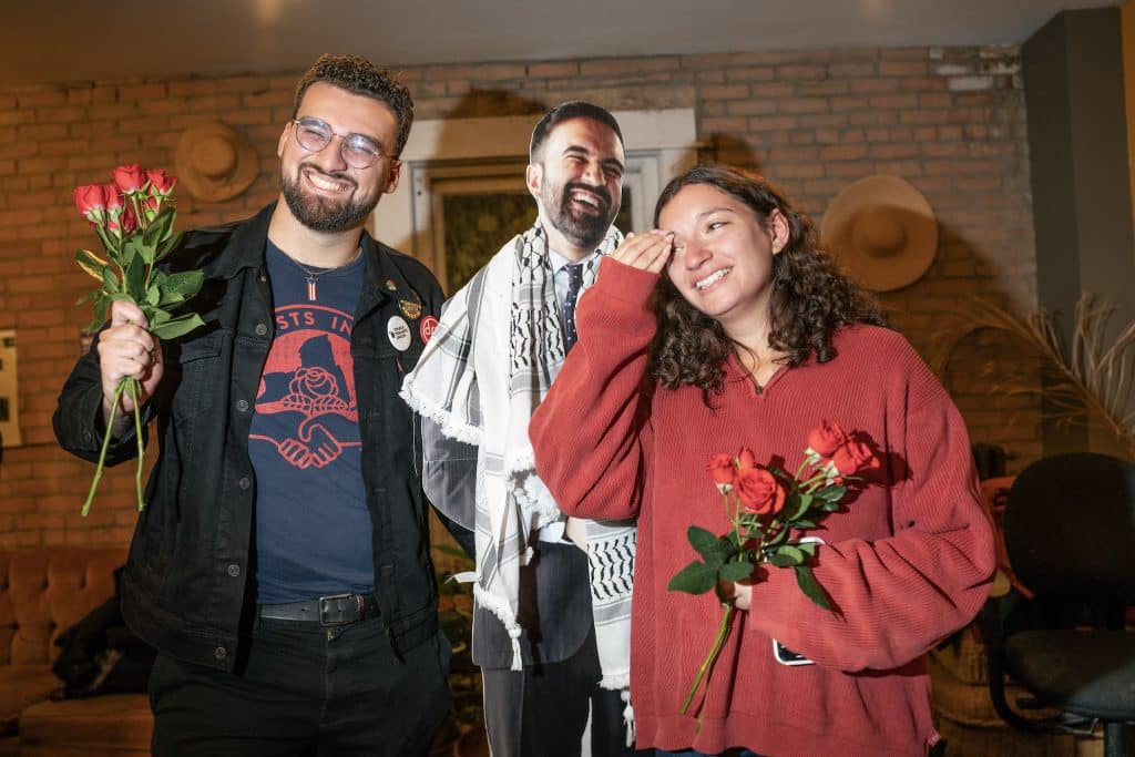 Hannah Shvets and Jorge Defendini pose with a cardboard cut out of Zohran Mamdani after winning their City Council elections on Nov. 4, 2025, at their watch party in Ithaca, NY. (Photo: Caleb Kaufman)