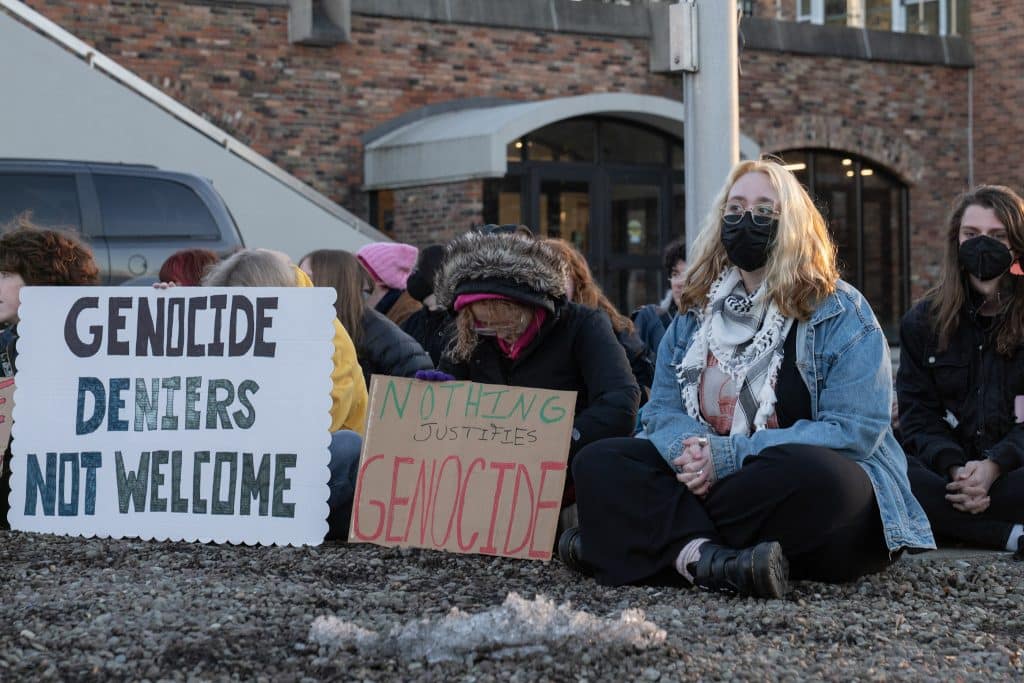 Quincey Fireside (right) organized a silent protest against Uriel Abulof's participation in a Hillel "side by side" talk discussing the Israel-Palestine conflict on Feb. 6, 2024, in Ithaca, NY. Fireside thought Abulof, an associate professor at Tel Aviv University, downplayed Israel's oppression of Palestinians. (Photo: Caleb Kaufman)
