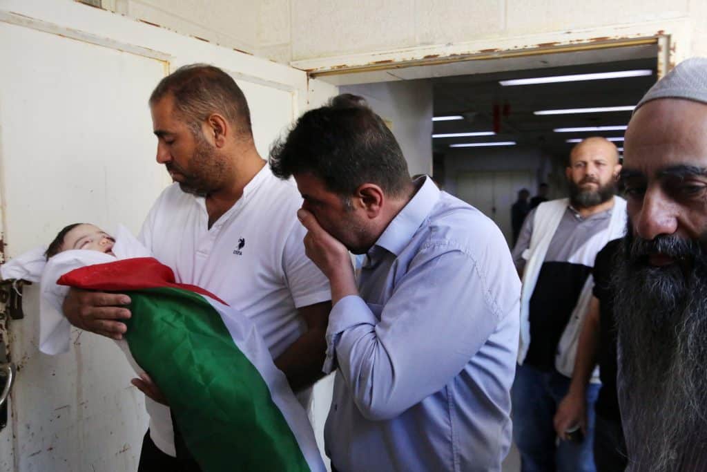 Family members of 7-month-old Sam Fahd Abu Haykal part in the infant's funeral in the West Bank city of Hebron on June 6, 2026. (Photo: by Mamoun Wazwaz/APA Image)