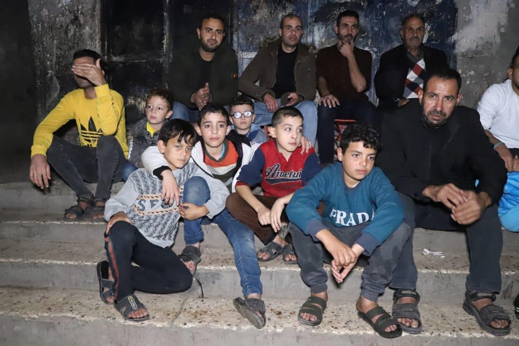 Palestinians in Gaza watch a football match in the street on a home TV during the 2022 FIFA World cup in Qatar, Gaza City, November 29, 2022. (Photo: Youssef Abu Watfa/APA Images)