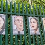 Posters of Palestine Action activists on trial, displayed on the gates of Woolwich Crown Court. (Photo: Aidan Frere-Smith)