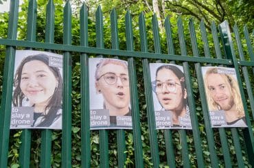 Posters of Palestine Action activists on trial, displayed on the gates of Woolwich Crown Court. (Photo: Aidan Frere-Smith)