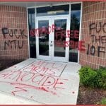 Property damage to a Rolls-Royce facility in Novi, Michigan, which had phrases such as “MTU ARMS GENOCIDE” and “FREE PALESTINE” painted on its exterior. Rolls-Royce produces parts for Israeli army vehicles. MTU is Rolls-Royce’s German subsidiary, which makes the engines for the Israeli army’s Merkava tanks. (Photo via US DOJ)