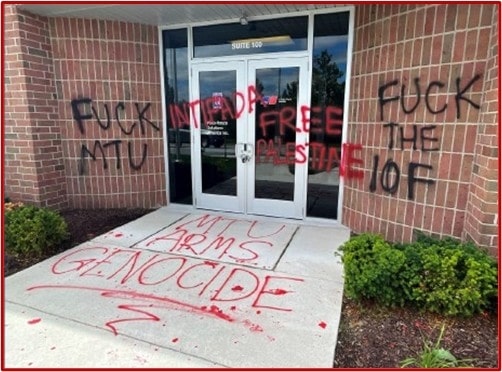 Property damage to a Rolls-Royce facility in Novi, Michigan, which had phrases such as “MTU ARMS GENOCIDE” and “FREE PALESTINE” painted on its exterior. Rolls-Royce produces parts for Israeli army vehicles. MTU is Rolls-Royce’s German subsidiary, which makes the engines for the Israeli army’s Merkava tanks. (Photo via US DOJ)