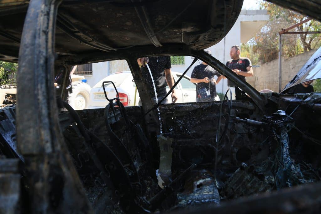 Palestinians inspect a burned car and tractor after they were set on fire by Jewish settlers in the village of Ramin, west of Nablus, July 16, 2026. (Photo: Mohammed Nasser/APA Images)