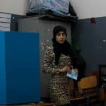 A Palestinian woman and citizen of Israel prepares to cast her ballot at a polling station in the Palestinian town of Umm al-Fahm on March 17, 2015. (Photo by Muammar Awad/apa images)