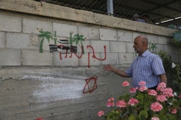 Palestinians inspect damage at the site of an attack carried out by Israeli settlers targeting Palestinian vehicles and property in the town of Surif, northwest of Hebron, May 17, 2026. (Photo: Mamoun Wazwaz/APA Images)
