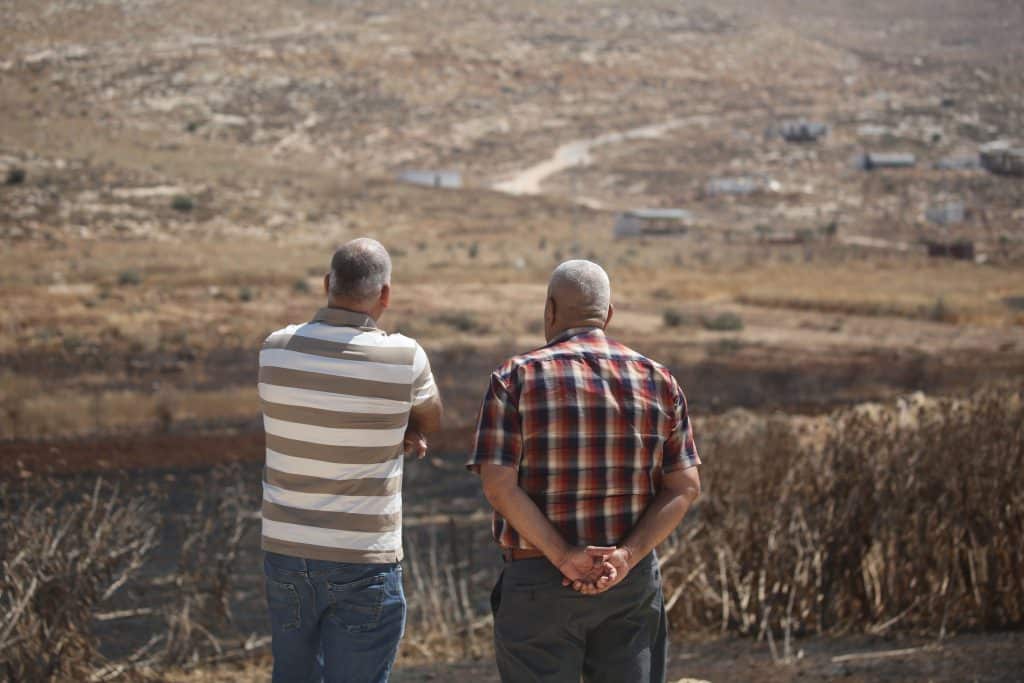 Residents of the Palestinian village of Salem, east of Nablus, look over a newly-established Israeli settler outpost, July 27, 2026. (Photo: Mohammed Nasser/APA Images)