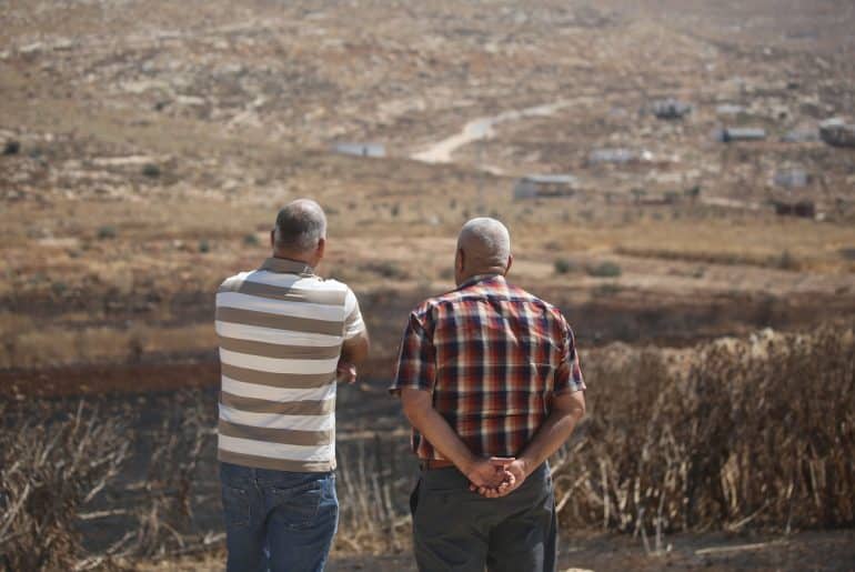 Residents of the Palestinian village of Salem, east of Nablus, look over a newly-established Israeli settler outpost, July 27, 2026. (Photo: Mohammed Nasser/APA Images)