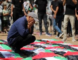 Palestinians attend the funeral of 112 members of the Hassayna and Abu Sharia clans, who were killed in an Israeli strike in November 2023 during the beginning of the Gaza genocide. They were laid to rest on August 4, 2026, after their remains were recovered from underneath the rubble, nearly three years later. (Photo: Bilal Osama/APA Images)