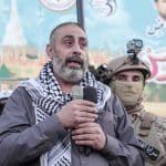 Fathi Khazem flanked by Jenin resistance fighters while speaking at a rally marking the 35th anniversary of the founding of the Islamic Jihad movement, Jenin, October 6, 2022. (Photo: APA Images)