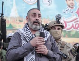 Fathi Khazem flanked by Jenin resistance fighters while speaking at a rally marking the 35th anniversary of the founding of the Islamic Jihad movement, Jenin, October 6, 2022. (Photo: APA Images)