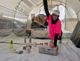 Palestinian fitness trainer Iman al-Mughir uses empty food cans and other waste items as part of her makeshift gym in Mawasi, Khan Younis, August 11, 2026. (Photo: Tariq Mohammad/APA Images)