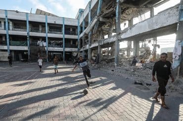 Displaced children play football in the courtyard of an UNRWA school in al-Bureij refugee camp in the central Gaza Strip on June 13, 2026. (Photo: Moiz Salhi/APA Images)