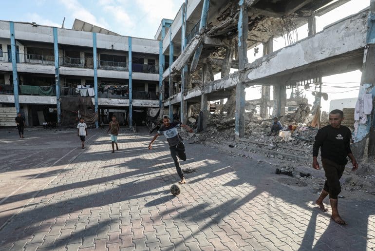 Displaced children play football in the courtyard of an UNRWA school in al-Bureij refugee camp in the central Gaza Strip on June 13, 2026. (Photo: Moiz Salhi/APA Images)