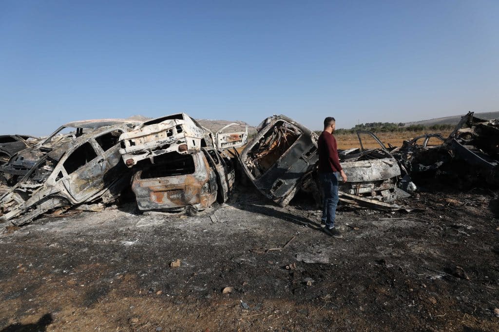 A Palestinian man inspects burnt scrap cars after an attack by Israeli settlers in the town of Huwwara in the Israeli-occupied West Bank, November 21, 2025. (Photo: Mohammed Nasser/APA Images)