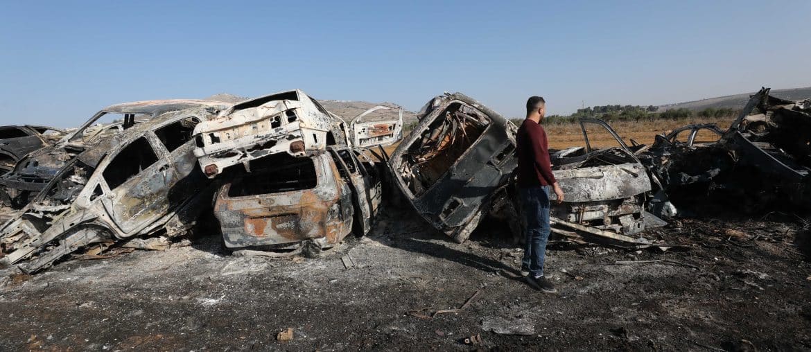 A Palestinian man inspects burnt scrap cars after an attack by Israeli settlers in the town of Huwwara in the Israeli-occupied West Bank, November 21, 2025. (Photo: Mohammed Nasser/APA Images)
