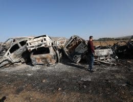 A Palestinian man inspects burnt scrap cars after an attack by Israeli settlers in the town of Huwwara in the Israeli-occupied West Bank, November 21, 2025. (Photo: Mohammed Nasser/APA Images)