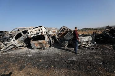 A Palestinian man inspects burnt scrap cars after an attack by Israeli settlers in the town of Huwwara in the Israeli-occupied West Bank, November 21, 2025. (Photo: Mohammed Nasser/APA Images)