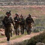 Israeli forces prevent Palestinians from planting olive trees on their land on Palestinian Land Day in the village of Qusra, March 30, 2022. (Photo: APA Images)