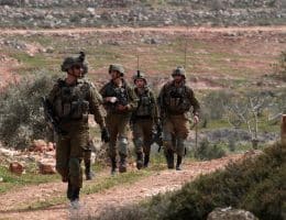 Israeli forces prevent Palestinians from planting olive trees on their land on Palestinian Land Day in the village of Qusra, March 30, 2022. (Photo: APA Images)