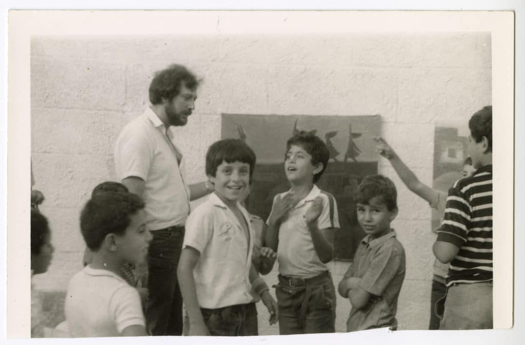 Sliman Mansour in Deir Ghassaneh at an art exhibition organized by Tayseer Barakat, 1984. (Photo: Palestinian Museum Digital Archive)
